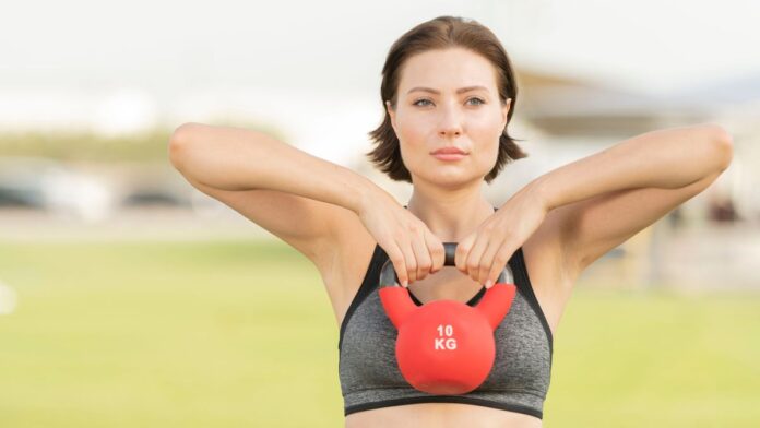 a woman performing a kettlebell upright row