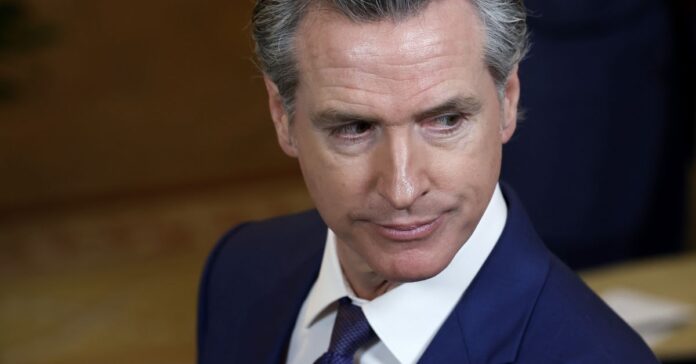 A photograph of a man’s face as he looks to the side.