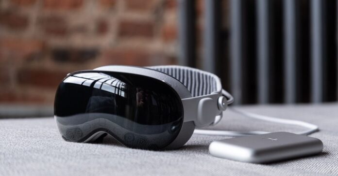 The Vision Pro sitting next to its battery.