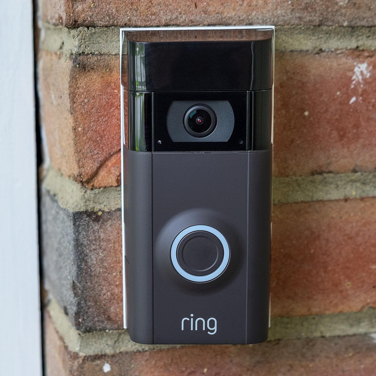 Ring video doorbell mounted on house