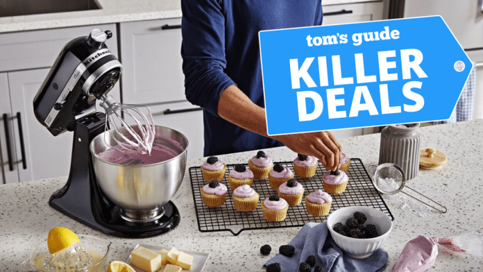 KitchenAid Classic Series 4.5 Quart Tilt-Head Stand Mixer K45SS, Onyx Black on kitchen counter surrounded by blackberry muffins