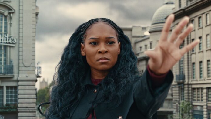 Sabrina (Nadine Mills) holds up her hand in Netflix