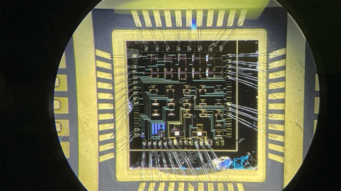 A wire-bonded die consisting of over 20 gallium nitride high-electron mobility transistors, seen here under a microscope, could be used in nuclear sensing equipment because of its high resistance to radiation