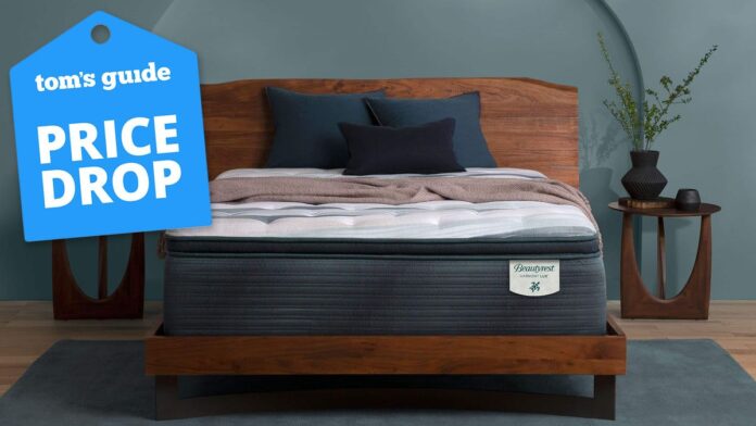 The Beautyrest Harmony Lux mattress on a bedframe in a bedroom, with a Tom