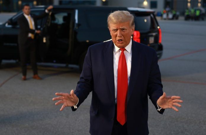 ATLANTA, GEORGIA - AUGUST 24: Former U.S. President Donald Trump speaks to the media at Atlanta Hartsfield-Jackson International Airport after being booked at the Fulton County jail on August 24, 2023 in Atlanta, Georgia. Trump was booked on multiple charges related to an alleged plan to overturn the results of the 2020 presidential election in Georgia.