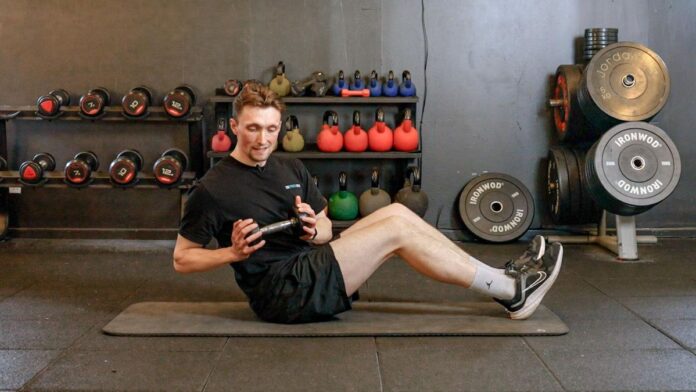 Alasdair Nicholl performing a dumbbell Russian twist