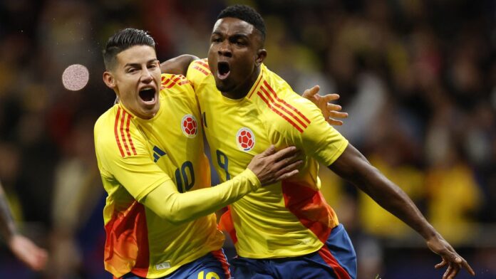 Jhon Cordoba (R) and James Rodriguez (L) celebrate a goal for Columbia in the country